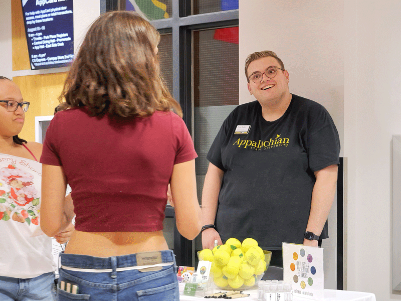 Campus outreach by ONE® College Ambassador Evan Foster, engaging students with safer sex resources, educational handouts, and condoms