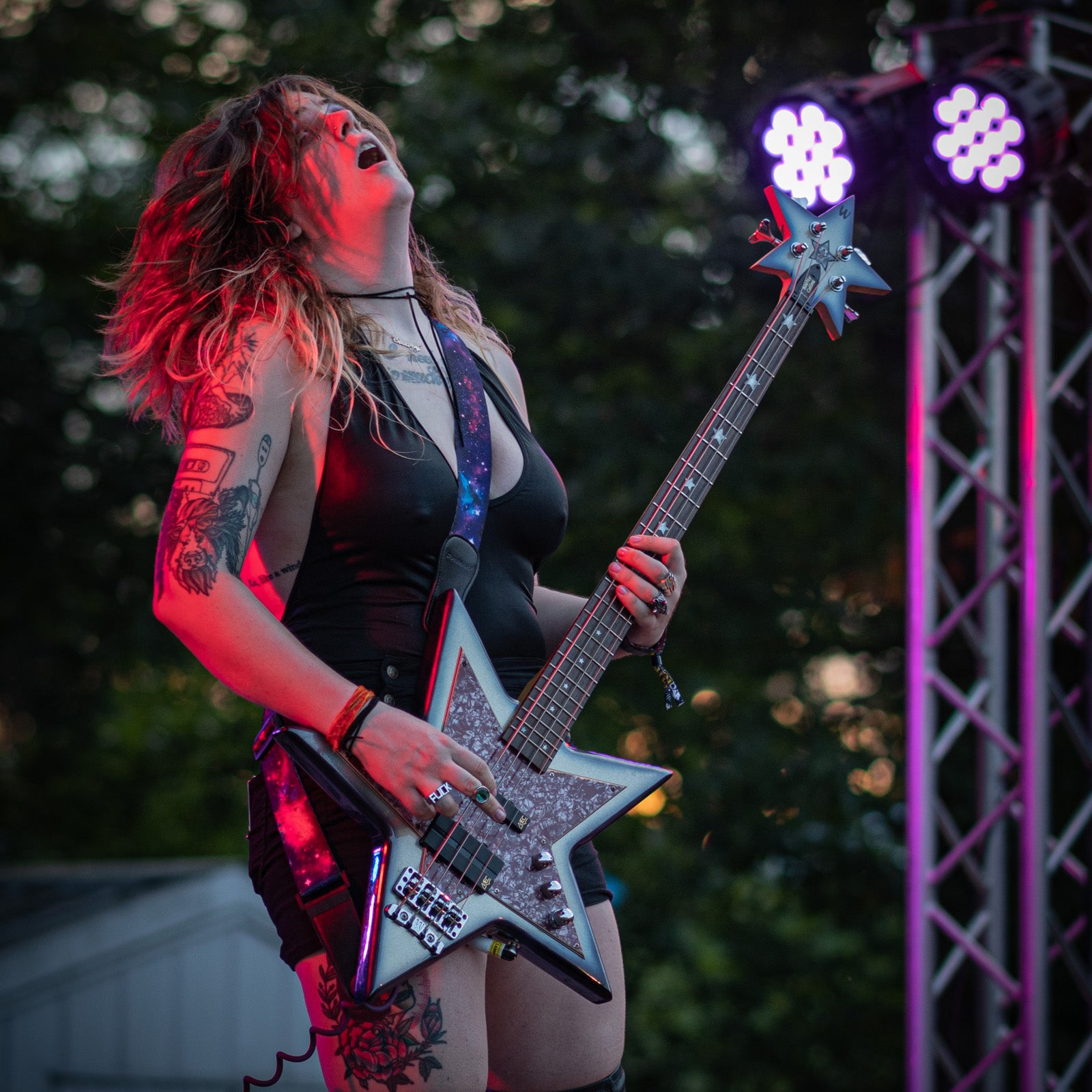 Image of person playing guitar on stage.