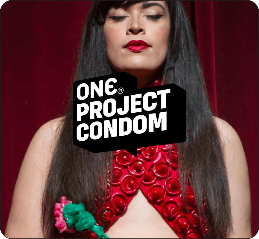 Woman wearing a red outfit with floral details against a red background, featuring 'One Project Condom' logo.